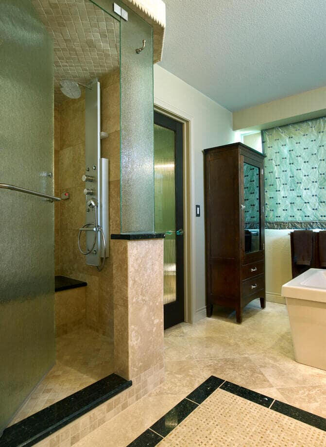 Teal bathroom with updated fixtures and tiling